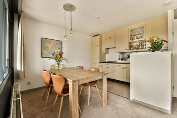 a kitchen and dining area in a small apartment with an open door leading to the living room on the right side