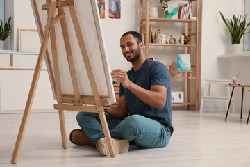 Young man painting in studio. Creative hobby