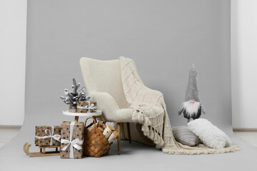 Stylish photo zone with armchair and Christmas decor in professional studio