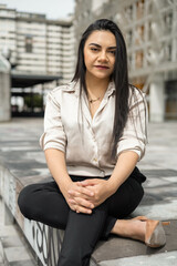 Fototapeta premium beautiful young latin woman with straight hair, wearing formal business attire, fashion and beauty in trend, entrepreneur in the day