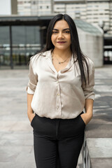 posing in a relaxed way a young latin woman with straight hair, wearing formal attire for business, fashion and beauty in trend, entrepreneur in the day