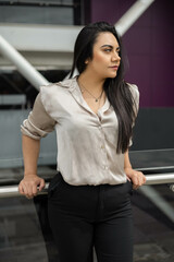 cheerful young person wear formal clothes as executive, latin woman in the city, youth beauty and fashion with daylight, modern businesswoman