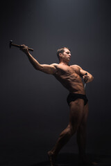 Create your own body, the concept of working on yourself. A muscular athlete sharpens his muscles...