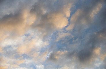 Fototapeta na wymiar Cloudscape, Colored Clouds at Sunset near the Ocean in a Blue Sky