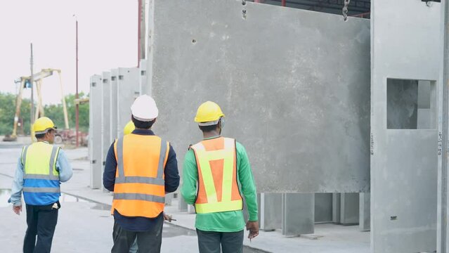 Architects and engineers plan and discuss construction plans at construction site.