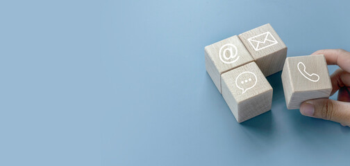 Icon of communication type on wooden cube. Contact us or Customer support hotline people connect.