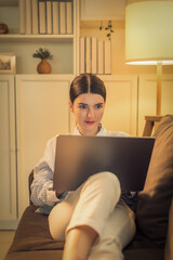 an engaged young asian businesswoman is seen diligently working on her laptop. She reclines...