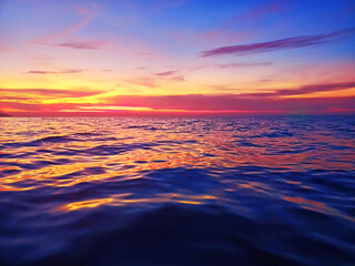 Sea sunset soft blurred background, ocean sunrise, tropical island beach dawn, dark blue water...