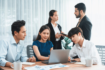 Professional Asian employee work together as team in corporate office, discussing business plans...