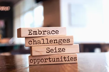 Foto op Plexiglas Wooden blocks with words 'Embrace challenges, seize opportunities'. © Uuganbayar