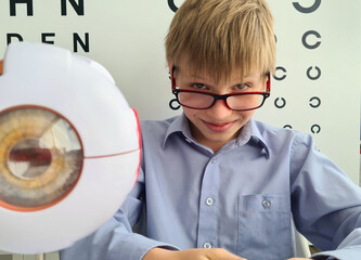Boy with glasses in ophthalmologist office concept
