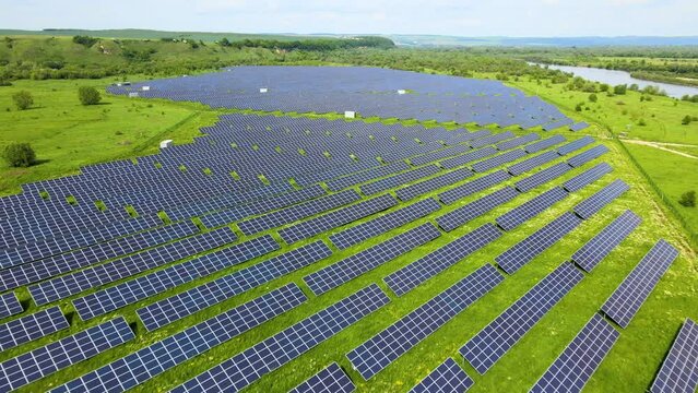 Aerial view of big sustainable electric power plant with many rows of solar photovoltaic panels for producing clean ecological electrical energy. Renewable electricity with zero emission concept