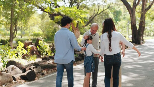 Happy Multi-generation Asian family smiling and hugging in the park, Relationship of love for Big Asia family in nature concept