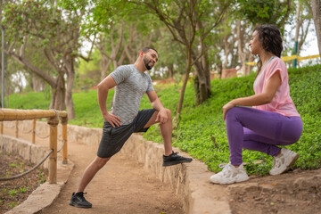 Couple in sportswear resting in the park