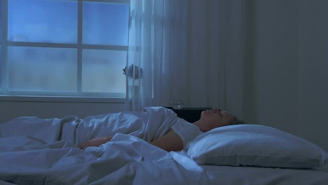 Sleeping woman suffers from sleepwalking at night while sleep. 