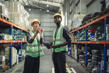 Fototapeta na wymiar Warehouse supervisor uses two way radio for seamless communication and connectivity with staff across various departments.Perform daily inventory monitoring and updates, order new parts as needed