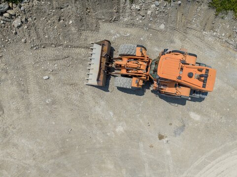 Aerial View Of Bulldozer On Construction Site And Mining Industry. Heavy Machinery For Earth Moving.