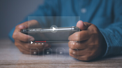 Man playing video game on his mobile phone. Online movie streaming with smartphone. Person watching video on internet with an imaginary video player service.