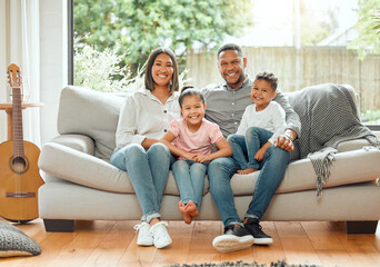 Family in portrait, parents and children smile, relax on couch with happiness and love while at home. Bonding, care and happy relationship, people together in house living room with mom, dad and kids