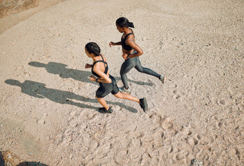 Fitness friends running on the beach, women workout together with cardio and active body on sand...