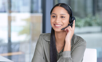 Woman with smile, callcenter with CRM and contact us, communication with headset and phone call in office. Female consultant in customer service, telemarketing or tech support with help desk job