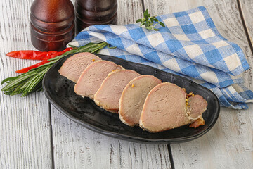 Baked pork tenderloin served rosemary