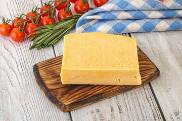 Piece of natural organic cheese over board