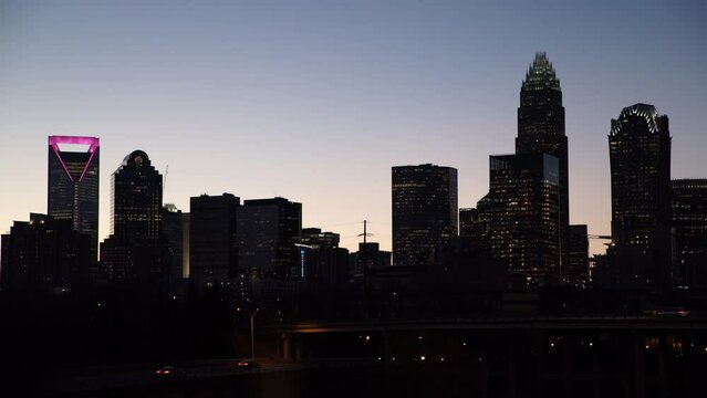 Lockdown Shot Of Illuminated Buildings By Bridge In City At Dusk - Charlotte, North Carolina