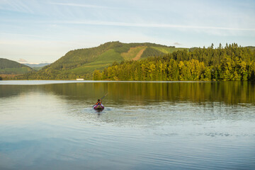 Kayaking on Dexter Lake at sunset. Oregon, USA
