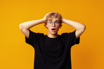 Fototapeta na wymiar Young man over yellow background with surprise facial expression