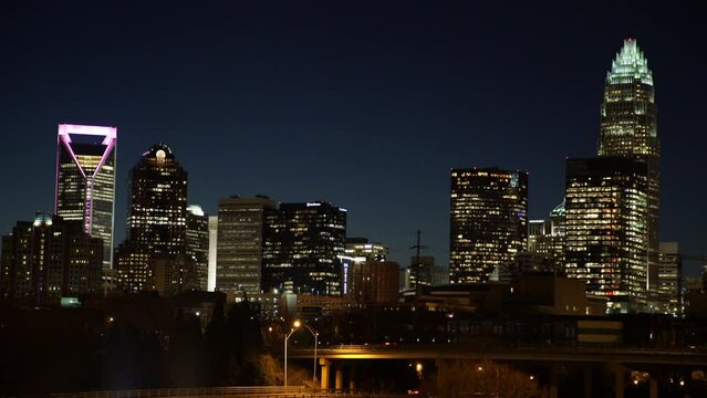 Lockdown Shot Of Illuminated Towers By Bridge In City At Night - Charlotte, North Carolina