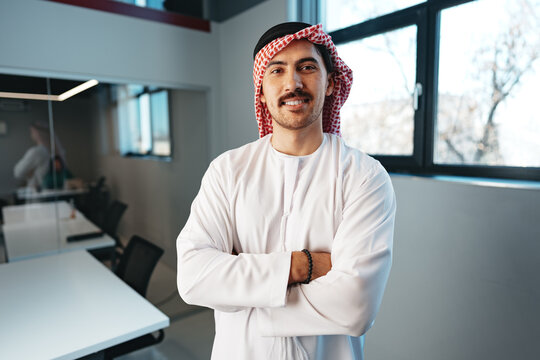 Successful muslim businessmen in traditional outfit in his office