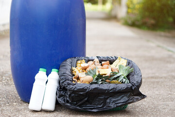 Basket with black plastic bag of food scrape and equipment for making compost. Concept, kitchen waste management, making compost from organic garbage. Environment conservation. Home composting        