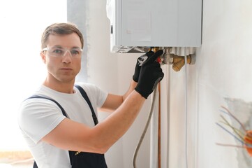 Young engineer adjusting autonomous heating