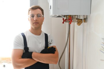 Professional boiler service: qualified technician checking a natural gas boiler at home