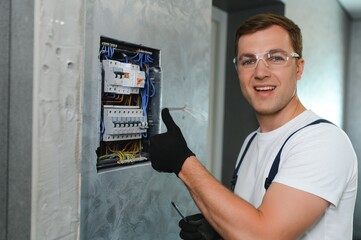 Electrician worker at work on an electrical panel