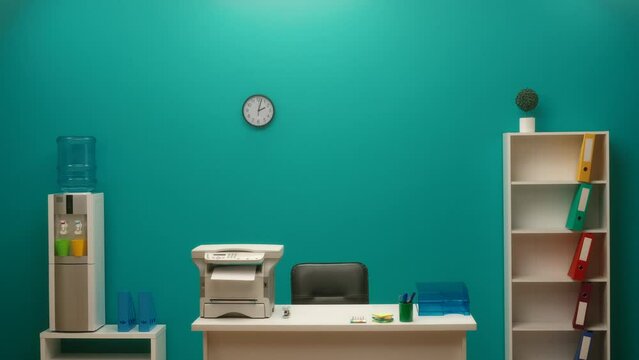 Interior of a modern office in blue tones with a printer on the desktop. The office is equipped with everything necessary for work and convenience for an employee, a table, a bookcase, a water cooler.