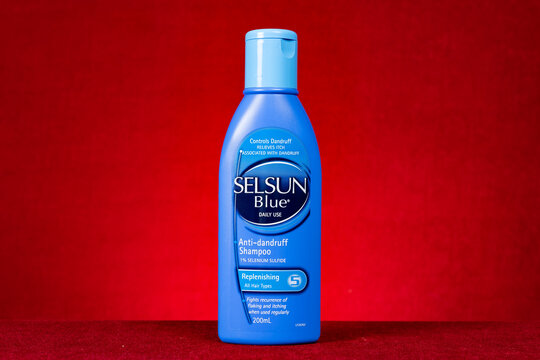 ZhongShan China-March 28,2023:bottle of Selsun Blue on red background horizontal composition.