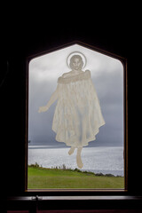 Engraved, etched glass window art depicting Jesus Christ at St. Faith's Anglican Church, Rotorua, North Island, New Zealand with volcanic lake geysers in background NZ