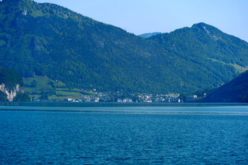 Scenic view of Lake Lucerne with Swiss Alps and mountain panorama and City of Brunnen in the background on a sunny spring day. Photo taken May 22nd, 2023, Lake Uri, Switzerland.