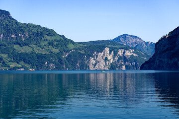 Scenic landscape with Lake Lucerne and mountain panorama in the Swiss Alps on a sunny spring day. Photo taken May 22nd, Sisikon, Canton Uri, Switzerland.