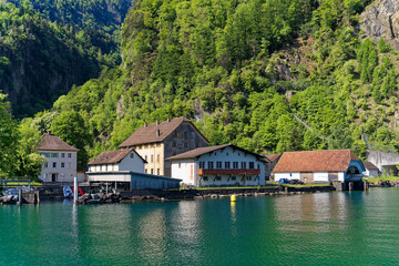 Fototapeta na wymiar View of Lake Uri with beautiful mountain panorama and pier at village Bauen on a sunny spring day. Photo taken May 22nd, 2023, Bauen, Switzerland.