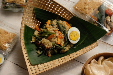 Urap Gudangan is is a typical Indonesian food made of boiled vegetables; there are spinach, long beans, bean sprouts, sliced carrots, and grated coconut that is seasoned, boiled eggs. Indonesian food.