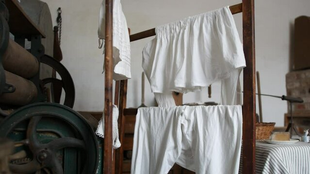 Washing hanging in Victorian laundry room with a large iron mangle