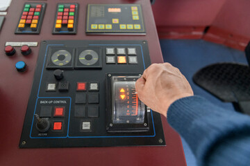 Navigational control panel with hand. Ship engine control. Navigational bridge.