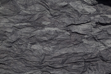 Dark background. Crumpled and wavy paper. Vintage, retro, design space.