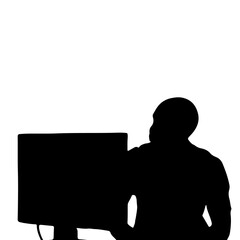 silhouette of a person looking at a computer screen