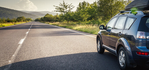 car for traveling with a mountain road © nickolya