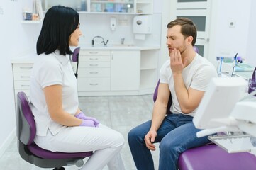 Fototapeta premium Dental care concept. Handsome young guy at the dentist's office.