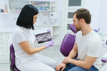 female dentist with male patient at clinic